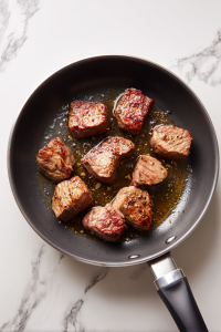 Heat 1 tbsp olive oil in a heavy-based pot over high heat. Sear beef on all sides until browned, then remove to a plate.