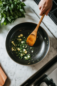 This image shows a pan filled with a mix of gourmet and cremini mushrooms being sautéed, with the mushrooms beginning to release their juices and brown for the steak marsala sauce.