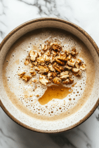 Add in 1/2 teaspoon of vanilla extract, and throw in those chopped walnuts and some raisins if you fancy them.