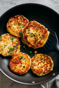 Spoon rice mixture onto the skillet, shaping into pancakes.