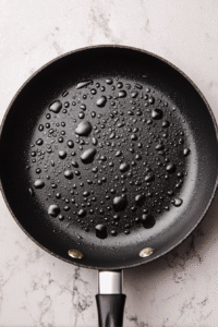 Heat skillet with oil on medium until water sizzles. Reduce to medium-low heat.