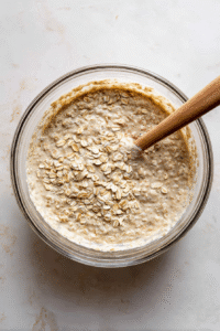 Pour batter into a bowl, stir in reserved oats. Let sit for 5-10 mins to thicken. Add more buttermilk if too thick.
