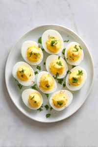 Scoop out yolks, mix with ingredients, and pipe into pickled egg whites.