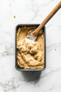 Pour the batter into your prepared loaf pan.