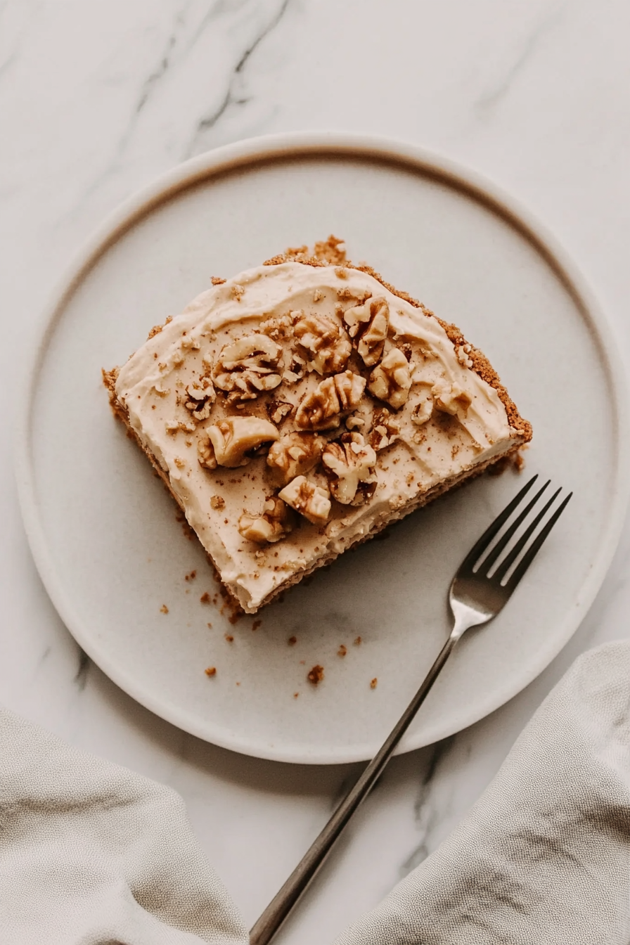 The frosted banana cake is refrigerated for 30 minutes to set the frosting and make slicing cleaner and easier.