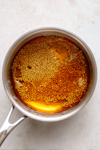 Combine ingredients for pickled mustard seeds and simmer.