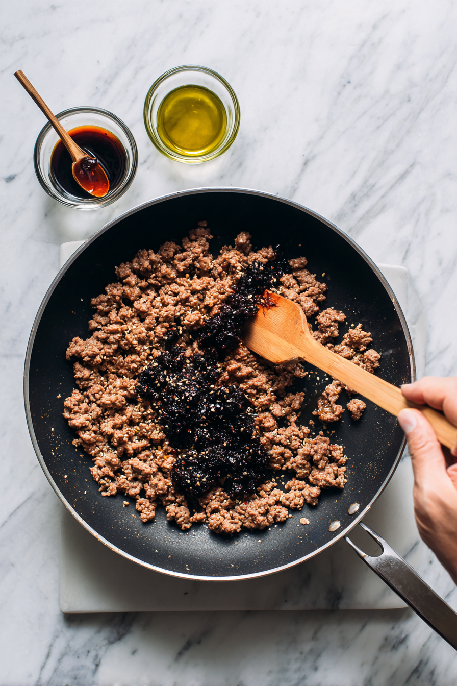 Add Seasonings: Stir in fermented black beans, chili paste (or chili bean sauce), soy sauce, and Sichuan peppercorns. Mix well to combine.