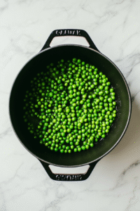 Add peas and liquid: Drain the soaked peas and add them to the pot. Pour in vegetable or chicken broth (or water), enough to cover the peas by about an inch.