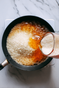 Throw in the rice, give it a good stir, and cover it up with a lid. Lower the heat to keep it simmering.