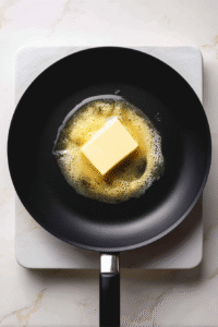 In a saucepan over medium-high heat, melt butter. Make sure it doesn't burn.