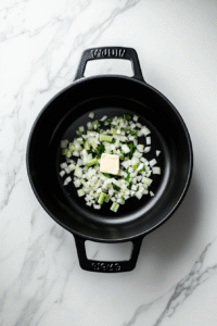 Saute aromatics: In a large pot or Dutch oven, sauté onions, carrots, celery, and garlic in oil or butter until softened.