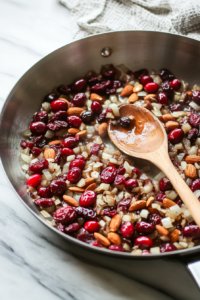 Sautéing Onion with Almonds, Cranberries, and Dates for Saffron Rice Layer