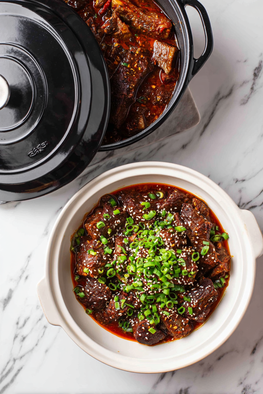 Serve: Transfer the galbi jjim to a serving platter or individual bowls. Garnish with chopped green onions and sesame seeds if desired. Serve hot with steamed rice and other side dishes.
