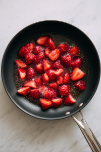 Half or quarter the strawberries. Add them to a pan and let them simmer over very low heat for 15 minutes.