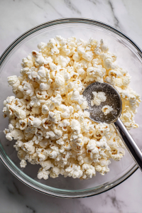 Transfer the kettle corn to a large bowl and allow it to cool before serving.