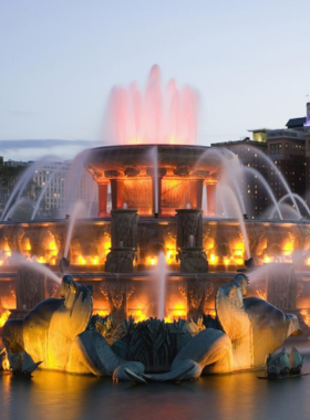 A stunning view of the Eiffel Tower illuminated at dusk, surrounded by a beautifully lit Parisian skyline. The iconic landmark stands majestically against the twilight sky, showcasing its intricate iron lattice structure and glowing lights. The scene captures the romantic essence of Paris, with the Seine River in the foreground reflecting the tower's glow. This image symbolizes the charm and allure of the city, making it a perfect representation of travel, romance, and iconic architecture.