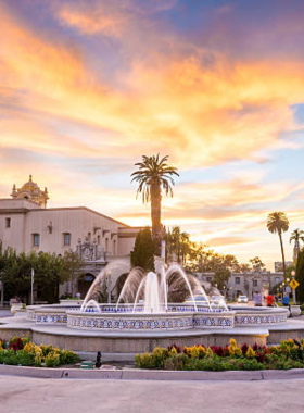 A stunning twilight view of Balboa Park in San Diego, California, showcasing its iconic architecture and glowing lights. The image captures the park’s historic buildings and lush landscape, inviting visitors to explore its rich cultural and recreational spaces. Balboa Park is a beloved landmark, known for its museums, gardens, and scenic beauty.