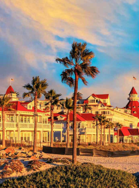 A sunny beach scene on Coronado Island, San Diego, featuring pristine sandy shores and calm waves. The image captures the relaxed coastal ambiance that attracts visitors to Coronado Island, known for its beautiful beaches and historic Hotel del Coronado. This spot is a favorite for beachgoers and those seeking a peaceful escape.
