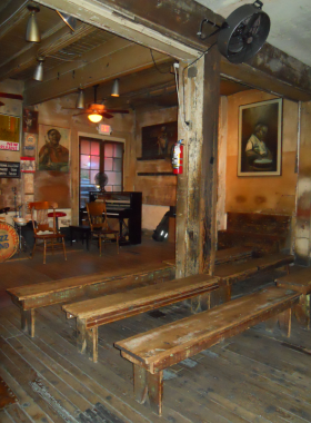 New_Orleans_French_Quarter_Balconies Detailed view of ornate ironwork balconies in the French Quarter of New Orleans, decorated with lush hanging plants, capturing the historic charm and architecture of the neighborhood.