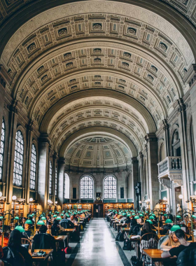 Bates Hall at Boston Public Library Bates Hall, a grand reading room at the Boston Public Library with high arched ceilings, large windows, and rows of green reading lamps. This elegant room is a quiet sanctuary for readers and visitors in Boston.