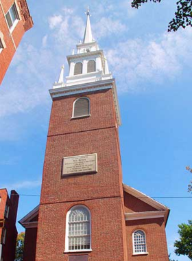 Old North Church, Boston The historic Old North Church in Boston, known for its colonial-era architecture and significant role in the American Revolution. The image shows the church’s tall steeple against a blue sky, symbolizing Boston’s rich historical heritage.