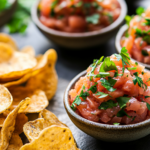Salmon Salad Served in Bowls with Fresh Herb Garnish and Crispy Chips