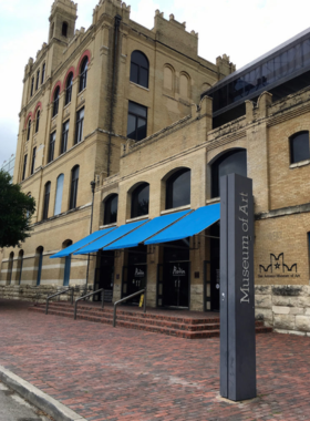 Exterior of a historical museum building: A grand, historic museum with Roman-inspired columns and ornate architectural details. The building stands tall and elegant, inviting visitors to explore art and history within.