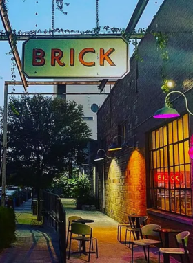 Historic brick walkway and surrounding greenery A well-maintained brick pathway bordered by lush, green plants and trees. The image captures the charm of historic architecture in a natural setting.