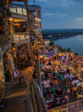 Oasis on Lake Travis with stunning views: A view of the Oasis restaurant on Lake Travis, featuring outdoor seating overlooking the water. The restaurant is known for its spectacular sunset views and lively atmosphere.