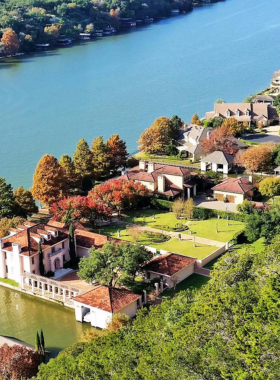 Mount Bonnell overlook with panoramic views: A panoramic view from the summit of Mount Bonnell, showcasing the city of Austin and the Colorado River below. The viewpoint is surrounded by greenery, offering a serene escape with breathtaking vistas.