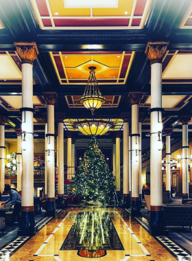Driskill Hotel's grand Christmas tree: The interior of the historic Driskill Hotel, beautifully decorated for the holiday season with a towering Christmas tree surrounded by elegant decor. The lobby's ornate architecture enhances the festive atmosphere, inviting guests to experience the holiday spirit.
