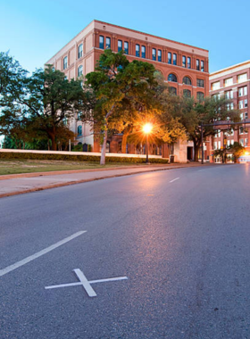 Dealey_Plaza_Dallas_TX.jpg "Historic Dealey Plaza in Dallas, Texas, featuring the Texas School Book Depository building, a site known for its significance in American history and popular with tourists."