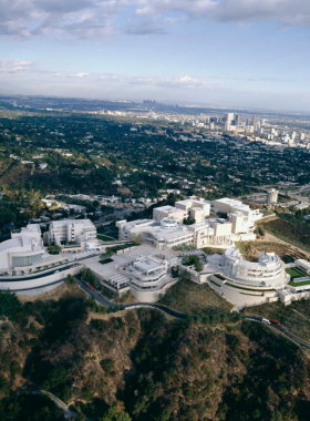 &ldquo;Aerial view of Los Angeles cityscape with mountains in the background, highlighting the vast urban sprawl and natural surroundings.&rdquo;