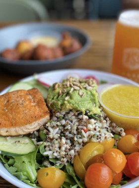 Peaceful Side Brewery A cozy exterior of The Peaceful Side Brewery and Craft Kitchen, set amidst lush greenery in Gatlinburg. The inviting entrance, adorned with outdoor seating, reflects a relaxed atmosphere perfect for enjoying craft beers and local cuisine.