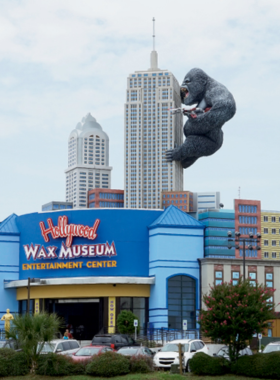 Wax_Museum_Myrtle_Beach A wide shot of the Myrtle Beach Wax Museum, showcasing lifelike wax figures of famous personalities. The museum’s exterior features a distinctive architectural design with a large entryway, drawing visitors eager to explore exhibits.