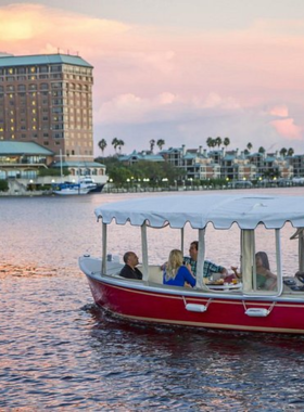 Electric Boat at eBoats Tampa A peaceful scene of an electric boat cruising along the Hillsborough River at eBoats Tampa, with visitors enjoying the relaxing experience while taking in the beautiful waterfront views.