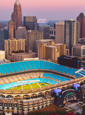 Bank-of-America-Stadium-Carolina-Panthers-Football-Game This image shows that passionate fans are cheering for the Carolina Panthers at Bank of America Stadium, enjoying an exciting NFL football game in a packed stadium atmosphere.