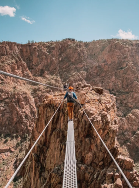 royal-gorge-bridge-and-canyon.jpg This image shows the Royal Gorge Bridge stretching across a deep canyon, with the Arkansas River flowing below and steep cliffs on either side.