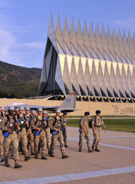 us-air-force-academy-chapel.jpg This image shows the iconic Cadet Chapel at the U.S. Air Force Academy, a striking architectural masterpiece with sharp spires against a clear blue sky.