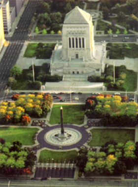 Indiana War Memorial Plaza with Fountain This image shows the Indiana War Memorial Plaza, featuring a fountain and large statues commemorating veterans in a peaceful setting."