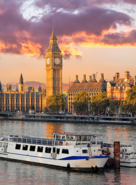 Thames River Cruise with London View This image shows a scenic Thames River cruise boat with views of iconic London landmarks in the background.