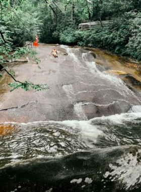 Grove Park Inn Views "This image shows the stunning views from Grove Park Inn, with the sun setting behind the mountains and the hotel’s historic architecture."
