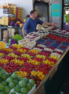 Jean-Talon Market Fresh Produce This image shows a vibrant display of fresh local produce at Jean-Talon Market, one of Montreal’s largest public markets, offering a wide variety of fruits, vegetables, and gourmet foods.