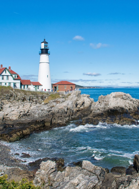 1. Portland Head Light This image shows the Portland Head Light, Maine's oldest lighthouse, standing tall against the backdrop of the Atlantic Ocean with its white structure and scenic surroundings.