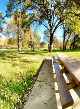 Discovery-Park-Sacramento-River This image shows a peaceful scene at Discovery Park, with people enjoying the view of the Sacramento River. The park offers a quiet retreat for picnics, walking, and water activities, making it a popular destination for outdoor enthusiasts.