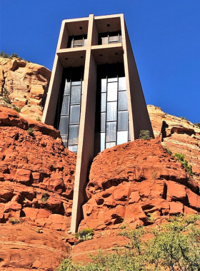Chapel-of-Holy-Cross-Sedona This image shows the Chapel of the Holy Cross, Sedona, nestled within the red rock cliffs, with its modern design contrasting beautifully against the natural desert backdrop.