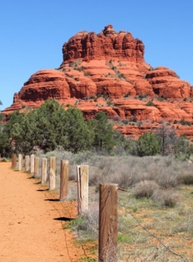 Bell-Rock-Sedona This image shows Bell Rock, one of Sedona’s most iconic landmarks, with hikers exploring its base and the towering red rock formation standing tall against the desert sky.