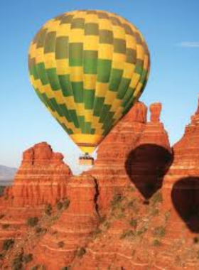Hot-Air-Balloon-Ride-Sedona This image shows a serene hot air balloon ride over Sedona’s red rock landscape, providing passengers with an unforgettable aerial view of the natural beauty below during sunrise.
