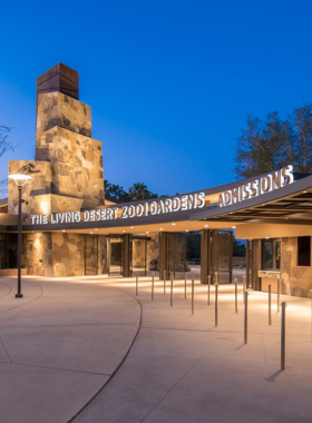 The Living Desert Zoo and Gardens This image shows giraffes at The Living Desert Zoo, with the animals grazing peacefully in a desert environment surrounded by various plant species from different deserts around the world.
