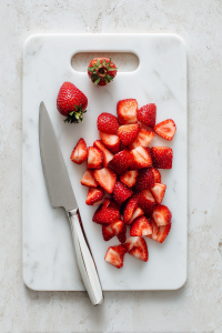 Cut the fresh strawberries into smaller pieces.